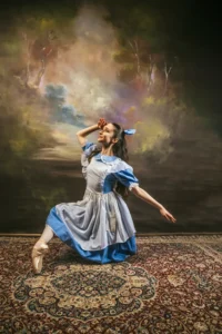A ballet dancer dressed as Alice from Alice in Wonderland