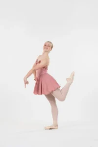 A solo female dancer posed and wearing pink.