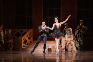 Two ballet dancers onstage dressed in black