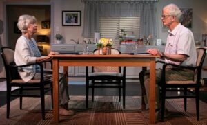 Two elderly people at kitchen table